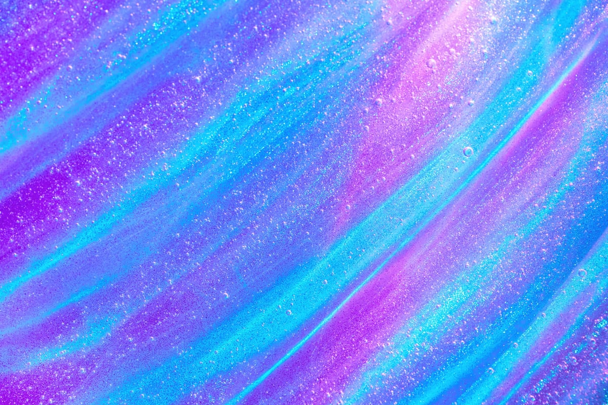 Purple, mint and glitter galaxy-coloured putty texture